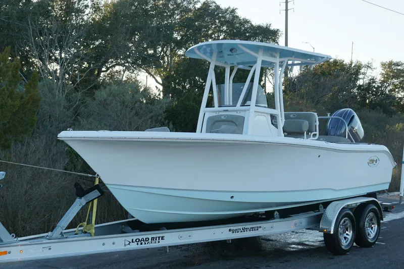 Slide: The Image of 2026 Sea Hunt Ultra 219 boat on trailer, parked outdoors. - 5