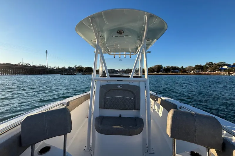 Slide: The Image of 2026 Sea Hunt Ultra 219 boat on water, featuring spacious seating and sleek design. - 7