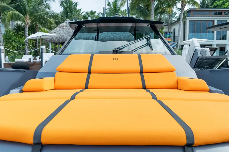 Slide: The Image of Luxurious 2024 Lekker 44 yacht with vibrant orange seating, docked near palm trees. - 5