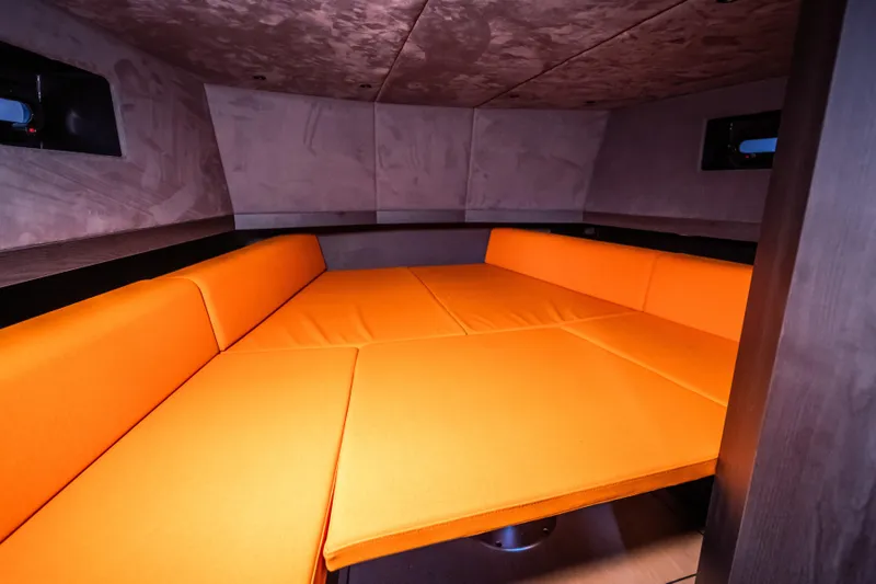 Slide: The Image of 2024 Lekker 44 interior with vibrant orange seating in a cozy cabin space. - 6