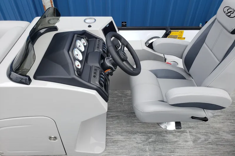 Slide: The Image of 2026 Bentley Pontoons Fish 223 N-Cruise helm with modern controls and comfortable captain's chair. - 14