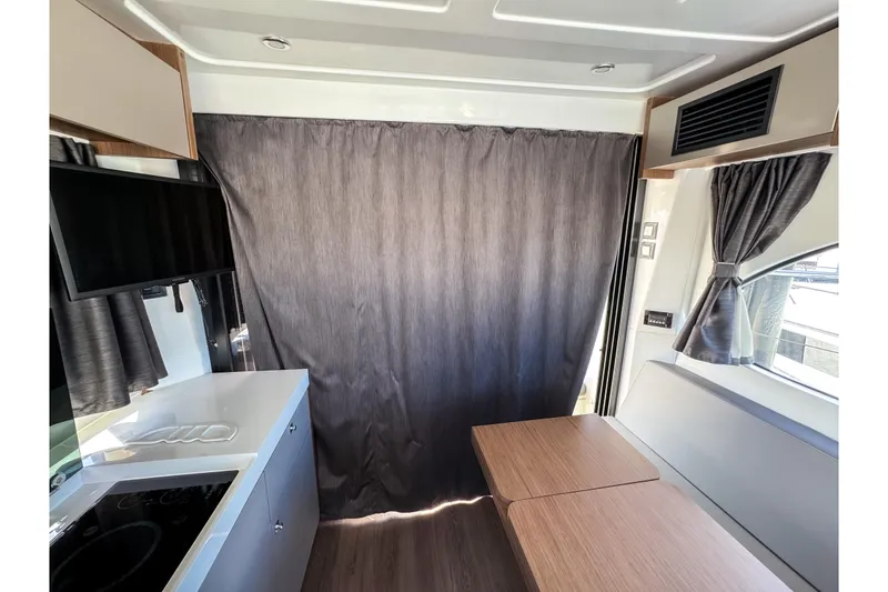 Slide: The Image of Interior of 2023 Beneteau Antares 11 with modern kitchen and dining area. - 12