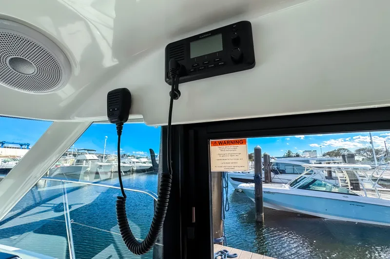 Slide: The Image of Interior view of 2023 Beneteau Antares 11 with marine radio and docked boats. - 20