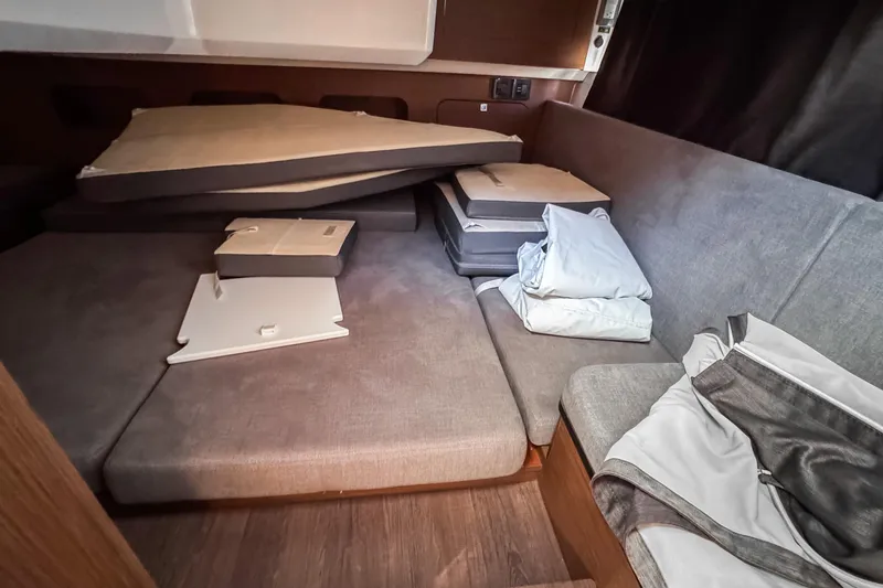 Slide: The Image of Interior cabin of 2023 Beneteau Antares 11 with cushions and bedding. - 25