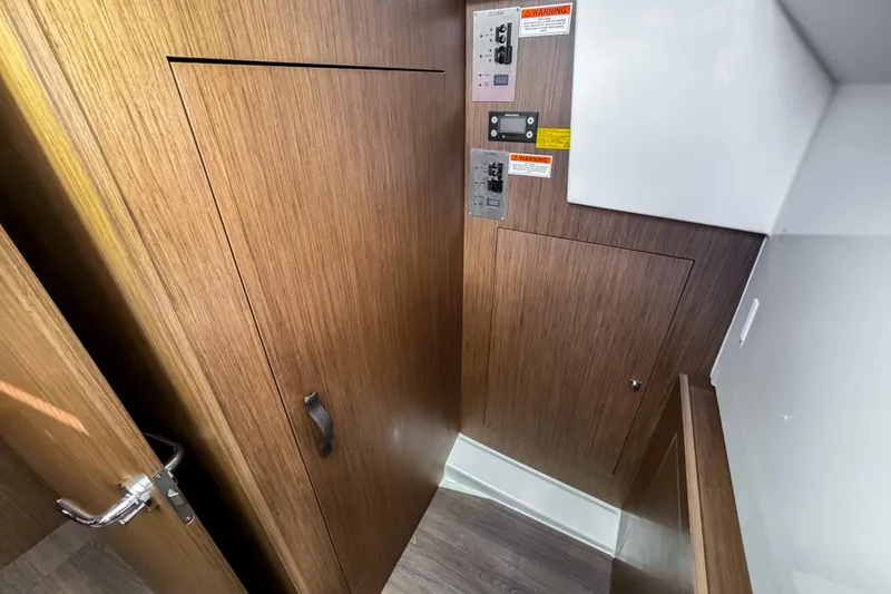 Slide: The Image of 2023 Beneteau Antares 11 interior with wooden paneling and control panels. - 28