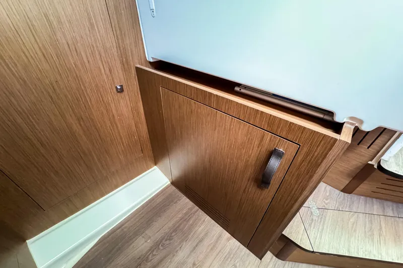 Slide: The Image of Interior of 2023 Beneteau Antares 11, featuring sleek wooden cabinetry and modern design. - 32