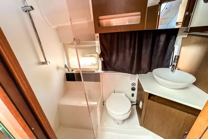 Slide: The Image of 2023 Beneteau Antares 11 bathroom with modern fixtures and wooden cabinetry. - 35