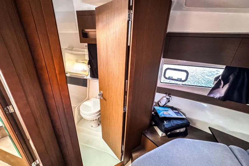 Slide: The Image of Interior of 2023 Beneteau Antares 11, featuring a compact bathroom and cozy cabin space. - 41