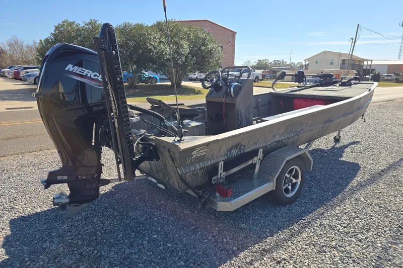 Slide: The Image of 2018 Pro-Drive 1754 boat with Mercury engine on trailer, parked on gravel. - 4