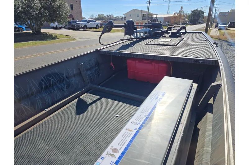 Slide: The Image of 2018 Pro-Drive 1754 boat interior with storage and equipment on a sunny day. - 7