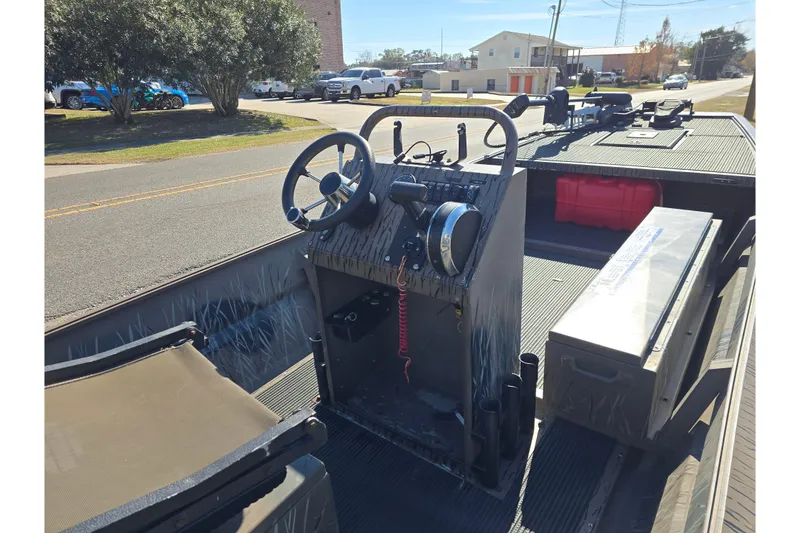 Slide: The Image of 2018 Pro-Drive 1754 boat interior with steering console and storage compartments. - 9