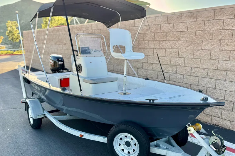 Slide: The Image of 2018 Caravelle Key Largo 161 boat on trailer with canopy and outboard motor. - 1