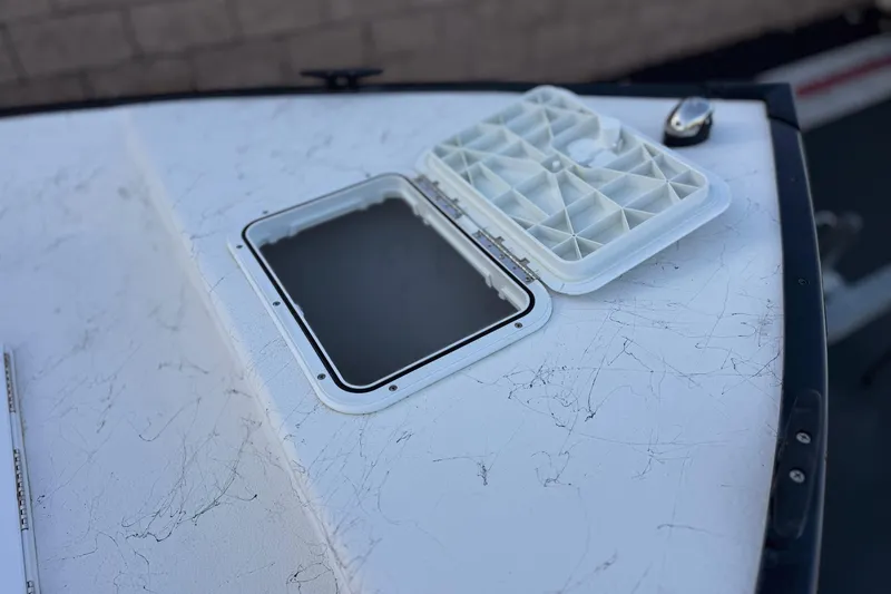 Slide: The Image of 2018 Caravelle Key Largo 161 boat hatch open on deck, showing interior compartment. - 10