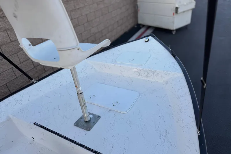 Slide: The Image of 2018 Caravelle Key Largo 161 boat interior with white seat and storage compartments. - 11