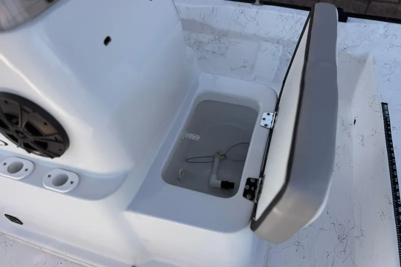 Slide: The Image of Open storage compartment on 2018 Caravelle Key Largo 161 boat, featuring built-in speaker. - 14
