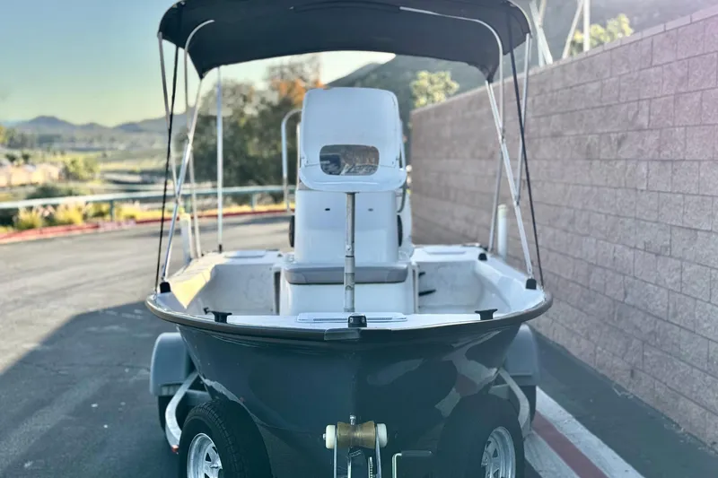 Slide: The Image of 2018 Caravelle Key Largo 161 boat on trailer, parked outdoors with scenic background. - 2