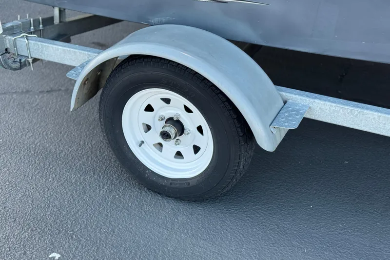 Slide: The Image of Trailer wheel of 2018 Caravelle Key Largo 161 boat on asphalt surface. - 22