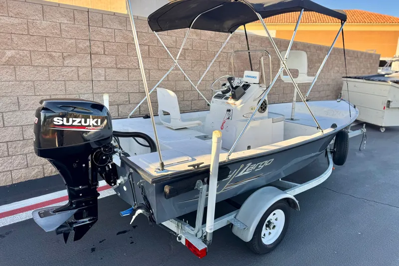 Slide: The Image of 2018 Caravelle Key Largo 161 boat with Suzuki outboard motor on trailer. - 5