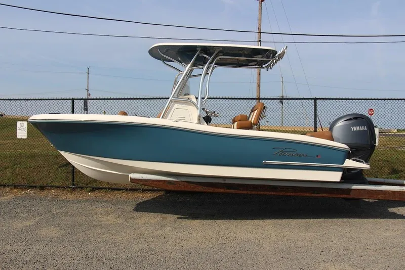 Slide: The Image of 2025 Pioneer 202 Islander boat with Yamaha engine, parked on a trailer. - 2