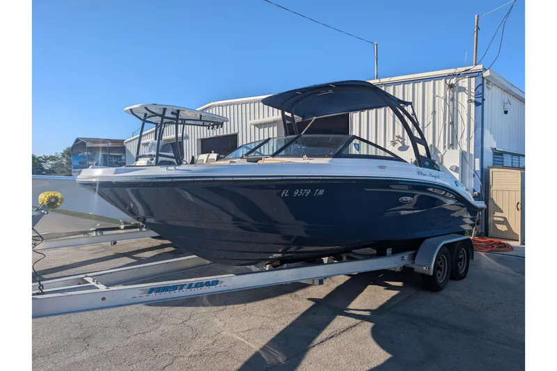The Image of 2021 Sea Ray 21 SPX OB boat on trailer, parked outside a building. - 0