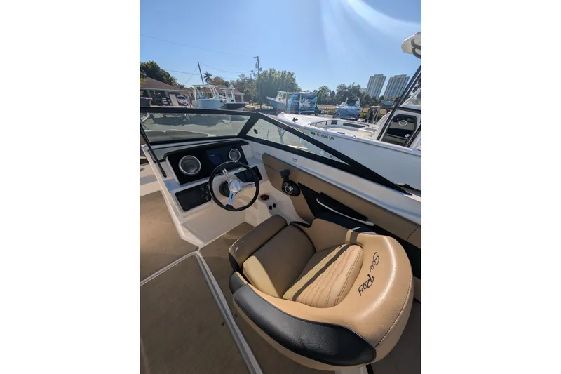 Slide: The Image of Interior of 2021 Sea Ray 21 SPX OB boat with steering wheel and tan seating. - 11