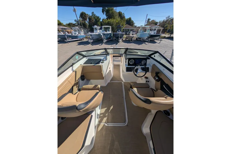 Slide: The Image of Interior view of 2021 Sea Ray 21 SPX OB boat with tan seating and steering console. - 12