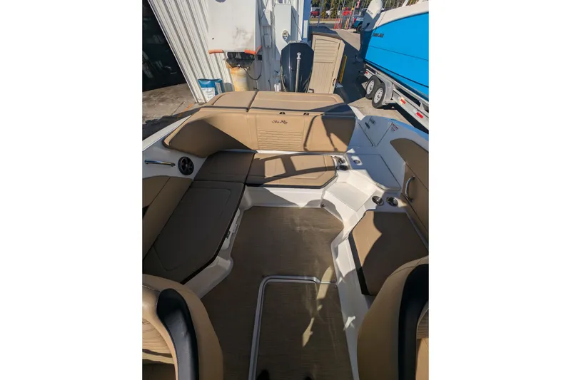 Slide: The Image of 2021 Sea Ray 21 SPX OB boat interior with tan seating and modern design. - 13