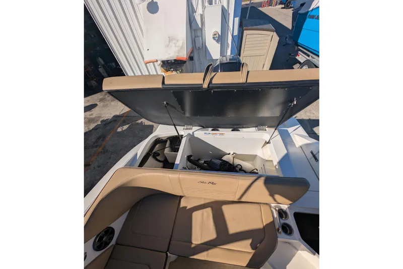 Slide: The Image of 2021 Sea Ray 21 SPX OB boat interior with open storage compartment. - 15