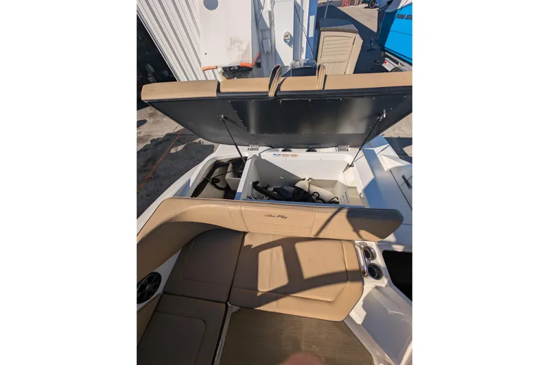 Slide: The Image of 2021 Sea Ray 21 SPX OB boat interior with open storage compartment. - 16