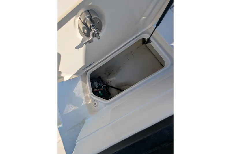 Slide: The Image of Open storage compartment on 2021 Sea Ray 21 SPX OB boat, showing interior details. - 18