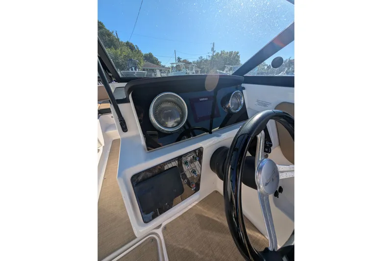 Slide: The Image of Dashboard of a 2021 Sea Ray 21 SPX OB boat with steering wheel and gauges. - 22