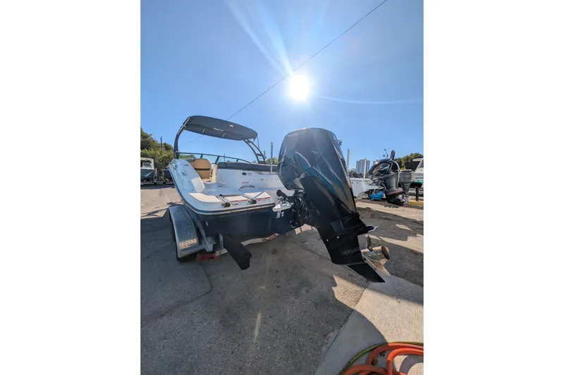 Slide: The Image of 2021 Sea Ray 21 SPX OB boat with outboard motor under bright sun. - 23