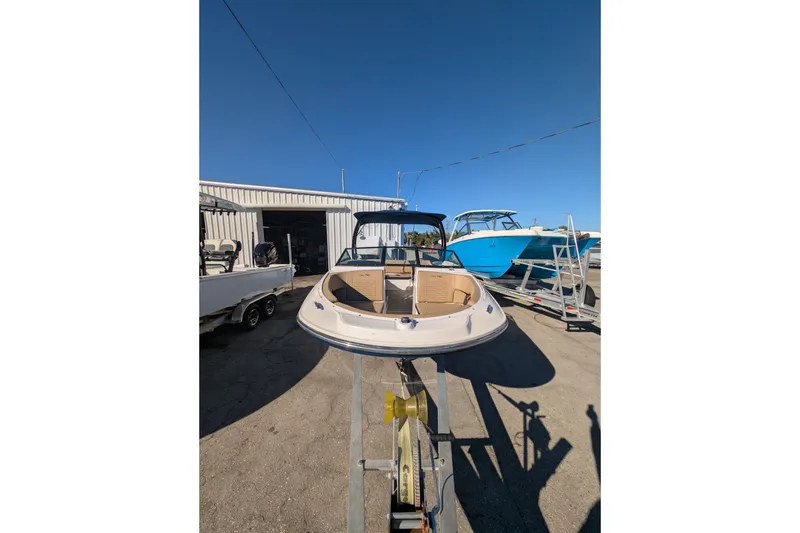 Slide: The Image of 2021 Sea Ray 21 SPX OB boat on trailer, outdoor display under clear blue sky. - 24