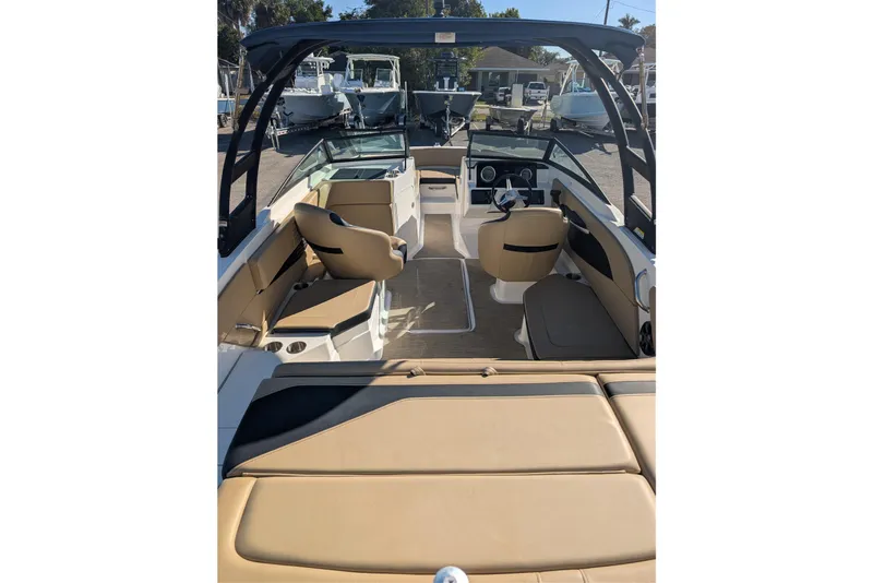 Slide: The Image of 2021 Sea Ray 21 SPX OB boat interior with tan seating and modern dashboard. - 3