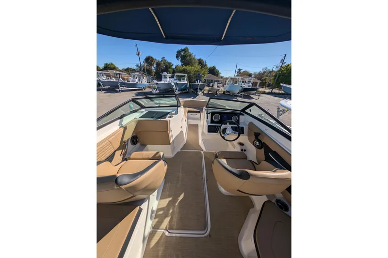 Slide: The Image of Interior view of 2021 Sea Ray 21 SPX OB boat with tan seating and steering wheel. - 6