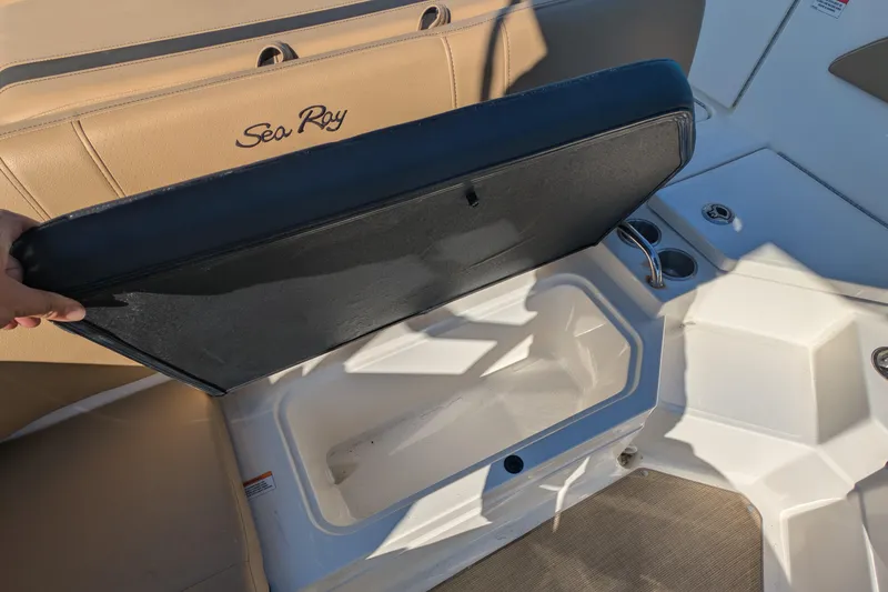 Slide: The Image of 2021 Sea Ray 21 SPX OB boat interior with open storage compartment and cup holders. - 7