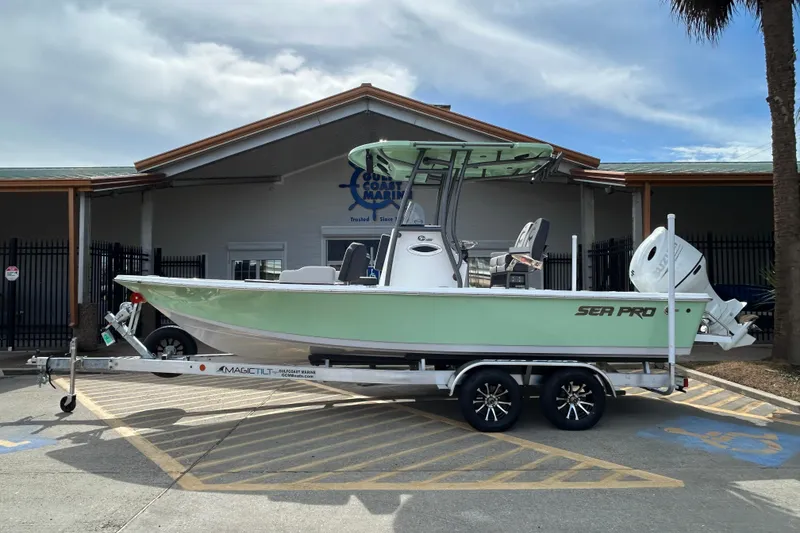 The Image of 2026 Sea Pro 230 Bay boat on trailer outside a marine dealership. - 0