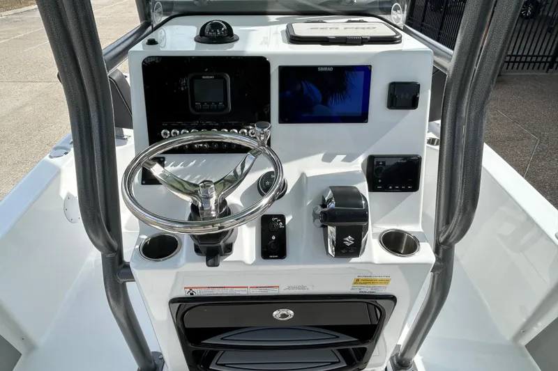 Slide: The Image of 2026 Sea Pro 230 Bay boat console with steering wheel and navigation controls. - 10