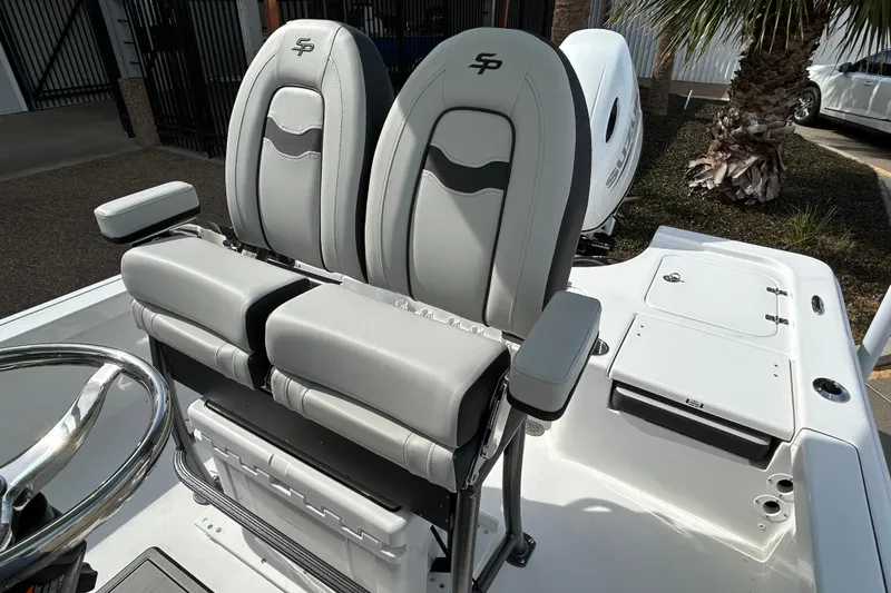 Slide: The Image of 2026 Sea Pro 230 Bay boat with dual cushioned seats and steering wheel. - 11
