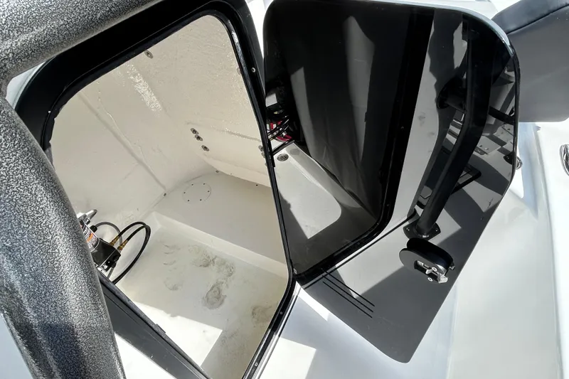 Slide: The Image of 2026 Sea Pro 230 Bay boat storage compartment with open hatch and visible interior. - 14