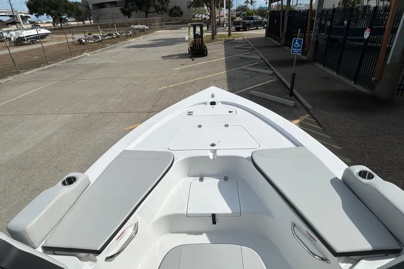 Slide: The Image of 2026 Sea Pro 230 Bay boat with spacious seating and storage, parked in a lot. - 15