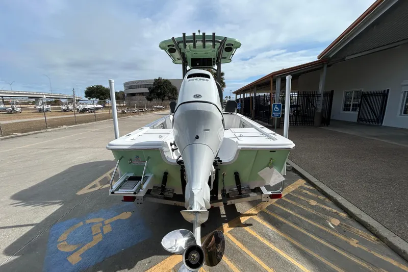 Slide: The Image of 2026 Sea Pro 230 Bay boat parked in a marina, rear view. - 5