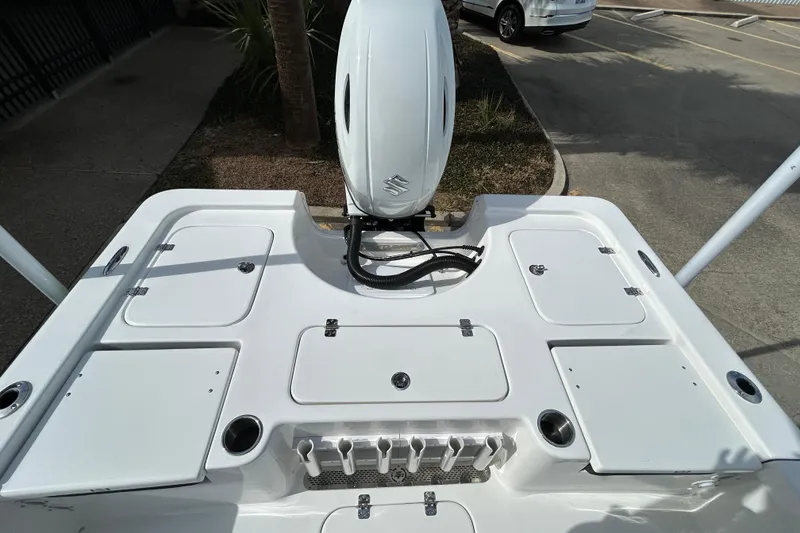 Slide: The Image of 2026 Sea Pro 230 Bay boat deck with storage compartments and outboard motor. - 6