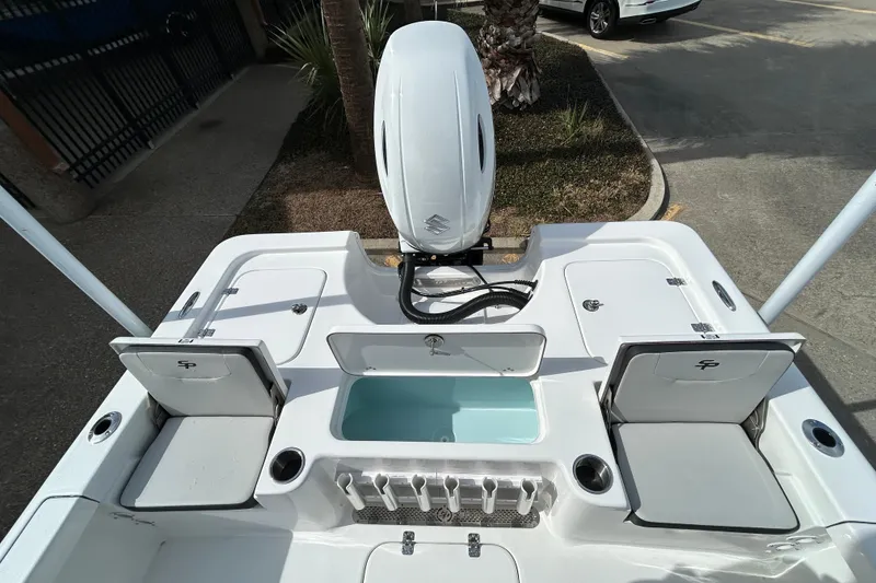 Slide: The Image of 2026 Sea Pro 230 Bay boat deck with storage compartments and motor. - 7
