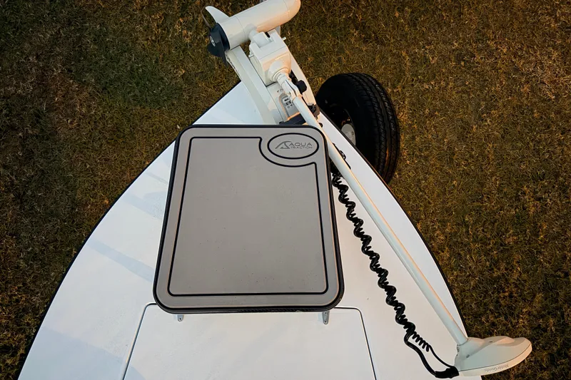 Slide: The Image of 2004 Hell's Bay Devilray boat deck with trolling motor and Aqua traction pad. - 16