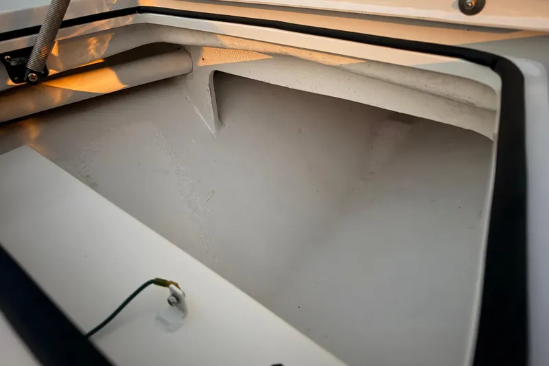 Slide: The Image of Storage compartment of a 2004 Hell's Bay Devilray boat, showcasing interior details. - 19