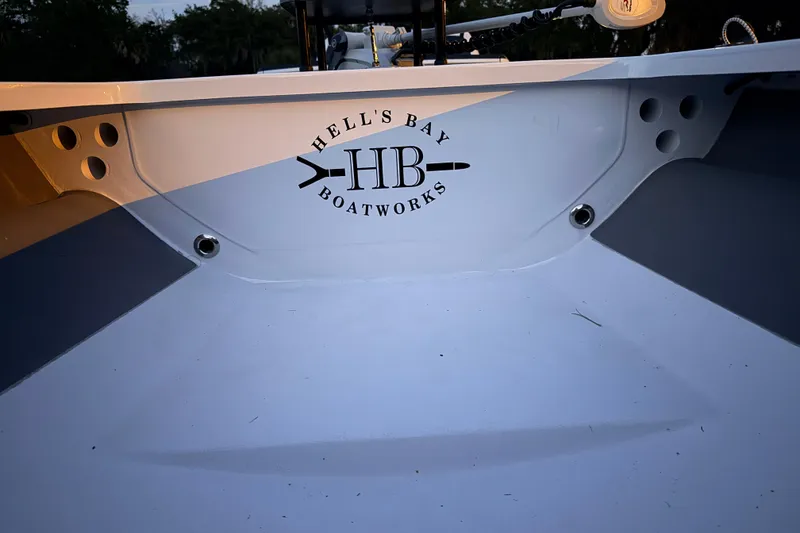 Slide: The Image of 2004 Hell's Bay Devilray boat interior with logo, evening lighting. - 22