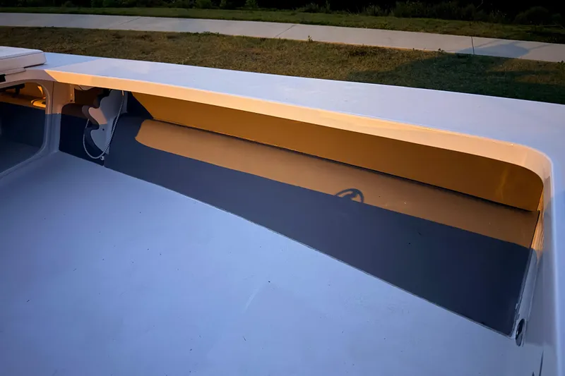 Slide: The Image of 2004 Hell's Bay Devilray boat interior with sleek design and storage compartment. - 24