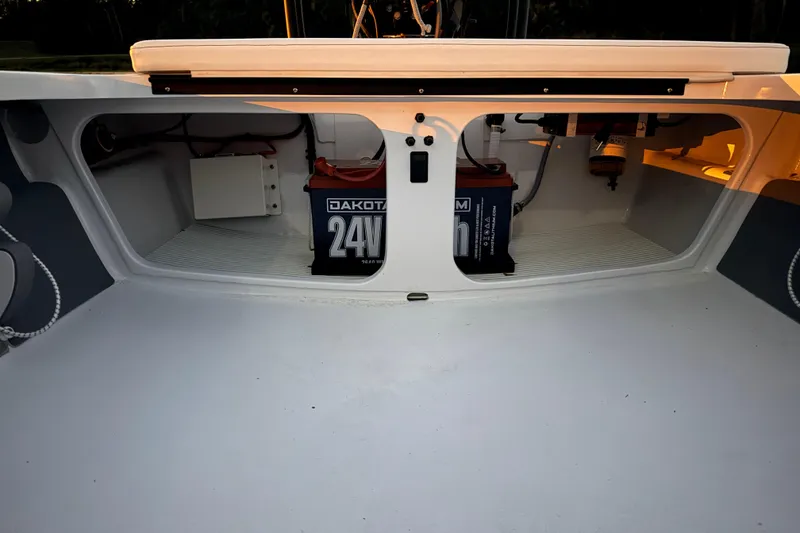 Slide: The Image of 2004 Hell's Bay Devilray boat storage compartment with Dakota 24V battery. - 25