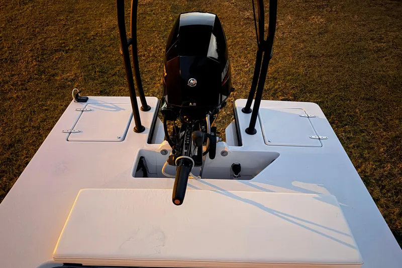 Slide: The Image of 2004 Hell's Bay Devilray boat with outboard motor, viewed from above on grass. - 26